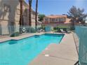 Inviting community pool with blue water and lounge chairs for relaxing summer days at 1472 Creslow Ct # 101, Las Vegas, NV 89102