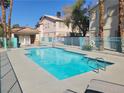Sparkling community pool with clear blue water, surrounded by lounge chairs at 1472 Creslow Ct # 101, Las Vegas, NV 89102