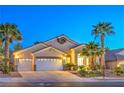 Attractive single-story home with a three-car garage, desert landscaping, and inviting front entrance at 1563 Cattle Ranch Pl, Henderson, NV 89002