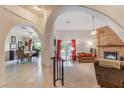 Inviting living room featuring a decorative brick fireplace, arches to other rooms and sliding glass doors to the backyard at 197 Ebb Tide Cir, Las Vegas, NV 89123