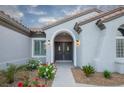 Inviting front entrance with a double door, arched entryway, and beautiful landscaping at 2099 Mountain City St, Henderson, NV 89052