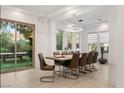 Bright dining room with modern lighting, large windows, and backyard view through sliding glass doors at 2240 Boutique Ave, Henderson, NV 89044