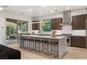 Modern kitchen with stainless steel appliances, a large island, and sliding doors to the backyard at 2240 Boutique Ave, Henderson, NV 89044