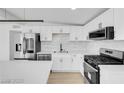 Modern kitchen featuring stainless steel appliances, sleek countertops, and ample cabinet space at 2801 Emmons Ave, North Las Vegas, NV 89030