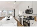Modern white kitchen featuring a large island, stainless steel appliances, and open layout at 4117 Sinew Ct, Las Vegas, NV 89129
