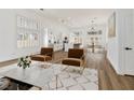 Open living area showcases wood floors, white walls, and a modern kitchen at 4117 Sinew Ct, Las Vegas, NV 89129