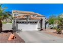 Beautiful two-story house with terracotta roof, desert landscaping and an attached two car garage at 5 Tarryall Ter, Henderson, NV 89074