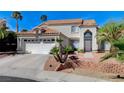 Beautiful two-story house with terracotta roof, desert landscaping and an attached two car garage at 5 Tarryall Ter, Henderson, NV 89074