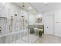 Luxurious bathroom showcases a seamless glass shower, rainfall showerheads, and a freestanding soaking tub at 5225 Villa Dante Ave, Las Vegas, NV 89141
