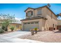 Side view of a charming two-story home with a two car garage, and desert landscaping at 53 Hoke Edward Ct, North Las Vegas, NV 89031