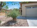 Home featuring desert landscaping with a yucca in front of a two-car garage at 53 Hoke Edward Ct, North Las Vegas, NV 89031