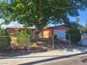 Charming single-story home featuring a large tree, well-maintained landscaping, and a fenced yard at 5317 Holmby Ave, Las Vegas, NV 89146