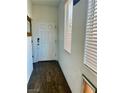 Bright foyer features wood-look tile flooring and natural light from the window with wood blinds at 5466 Scotch Cap Dr, Las Vegas, NV 89122