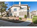 Exterior view of a condo featuring stucco, well-kept landscaping, and inviting walkways at 5710 E Tropicana Ave # 2218, Las Vegas, NV 89122