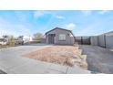 Charming single-story home with desert landscaping, new driveway, and contemporary block wall fencing at 60 Pecos St, Las Vegas, NV 89110