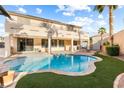Stunning backyard showcasing a refreshing pool, lush greenery, and a relaxing outdoor space at 623 Blue Snow River Ct, Henderson, NV 89002