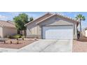 Charming single story home with desert landscaping, attached garage and tile roof at 628 Carlos Julio Ave, North Las Vegas, NV 89031