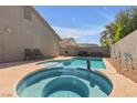 Backyard pool and jacuzzi with nice pavers and hardscape under a sunny blue sky at 628 Carlos Julio Ave, North Las Vegas, NV 89031