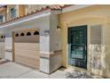 Close-up view of a townhome entrance and attached garage, highlighting the home's address at 6540 Angel Mountain Ave, Las Vegas, NV 89130