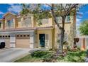 Lovely townhome with a well-maintained lawn, attached garage and a welcoming entrance at 6540 Angel Mountain Ave, Las Vegas, NV 89130