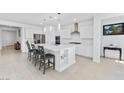 Bright, white kitchen featuring a large island with seating and stainless steel appliances at 6557 Corsari Ridge St, Las Vegas, NV 89166