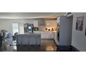 Modern, spacious kitchen with white cabinetry, stainless steel appliances, and a large island at 6624 Brandywine Way, Las Vegas, NV 89107