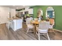 Charming dining area adjacent to the kitchen with a round table and stylish seating at 6957 Lynbridge St # 57, Las Vegas, NV 89166