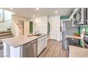 Modern kitchen featuring an island with stainless steel appliances and light countertops at 6957 Lynbridge St # 57, Las Vegas, NV 89166