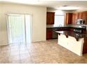 Well-lit kitchen area featuring tiled floors, wood cabinets, and stainless steel appliances at 7351 San Pablin St, Las Vegas, NV 89139