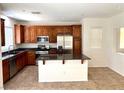 Open kitchen featuring a granite counter, central island, and stainless steel appliances at 7351 San Pablin St, Las Vegas, NV 89139