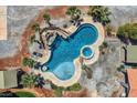 Aerial view of a luxurious backyard oasis with a custom-designed pool, hot tub, and serene water features at 7760 Haven St, Las Vegas, NV 89123