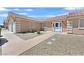 Welcoming front entrance with a double door and desert landscaping at 7925 Placid St, Las Vegas, NV 89123