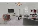 Bright, staged living room featuring vaulted ceilings, fan, decor, and modern furniture at 7925 Placid St, Las Vegas, NV 89123