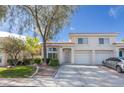 Charming two-story home with a well-manicured lawn and attached two-car garage at 7985 Simone Ave, Las Vegas, NV 89147