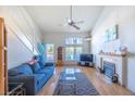 Inviting living area with a fireplace, lots of light, and wood laminate floors at 7985 Simone Ave, Las Vegas, NV 89147