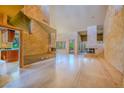 Open living room featuring a fireplace, marble floors, and access to outdoor views at 8199 Pinnacle Peak Ave, Las Vegas, NV 89113