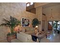 Grand living room featuring soaring ceilings, unique decor and neutral furniture at 8199 Pinnacle Peak Ave, Las Vegas, NV 89113
