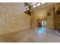 Spacious living room with high ceilings, unique textured walls, and marble floors at 8199 Pinnacle Peak Ave, Las Vegas, NV 89113