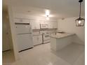 Bright kitchen featuring white cabinetry, granite counters, and modern appliances at 833 Hedge Way # 2, Las Vegas, NV 89110