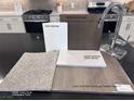 Selections include a modern faucet, quartz countertops, stainless steel appliances, and neutral color palette at 9233 Hudson Yards Ct, Las Vegas, NV 89148
