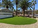 Palm Hills entrance sign featuring lush landscaping, manicured lawn, and tropical palm trees at 96 Saint Johns Wood Ave, Henderson, NV 89002