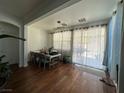 Bright dining area with hardwood floors with a dining table set with seating for six at 9628 Scrub Jay Ct, Las Vegas, NV 89148