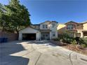 Two-story home with a two-car garage, desert landscaping, and an ample driveway for parking at 9628 Scrub Jay Ct, Las Vegas, NV 89148