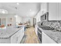 Modern kitchen with granite countertops, stainless steel appliances, and spacious island at 10266 Sweet Holly Pl, Las Vegas, NV 89149