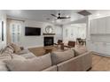 Cozy living room with a fireplace, ceiling fan, and comfortable seating area at 10729 Grey Havens Ct, Las Vegas, NV 89135