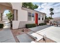 Charming single-story home with a red door, meticulous landscaping, and inviting curb appeal at 1116 Piazza Telle, Henderson, NV 89052