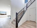 Bright entryway with wood-look floors, black metal staircase, and high ceilings at 1321 Crimson Sunbird Ave, North Las Vegas, NV 89084
