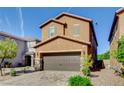Charming two-story home boasts a brick driveway, two-car garage and well-manicured landscaping at 139 Fulgora St, Henderson, NV 89074