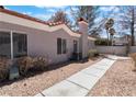 The exterior of the home featuring large windows, greenery, and a sidewalk at 1838 N Jones Blvd, Las Vegas, NV 89108