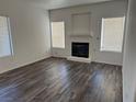 Spacious living room features a fireplace and contemporary wood-look flooring under natural light at 1838 N Jones Blvd, Las Vegas, NV 89108
